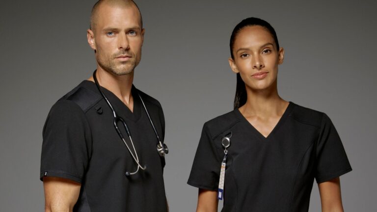 Two doctors wearing black dental scrubs